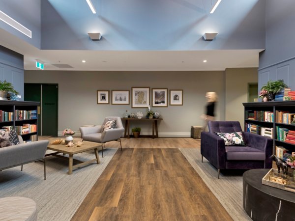 Interface carpet tiles in a senior living common area with clear colour transitions and simple patterns that support wayfinding for residents with dementia