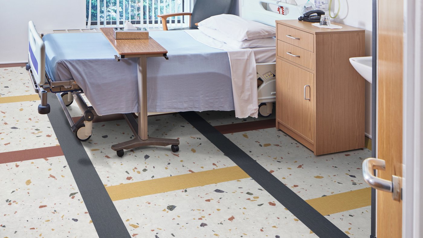 Karndean Opus luxury vinyl tile in a patient room, showing stone-effect design with safety performance for aged care bedrooms
