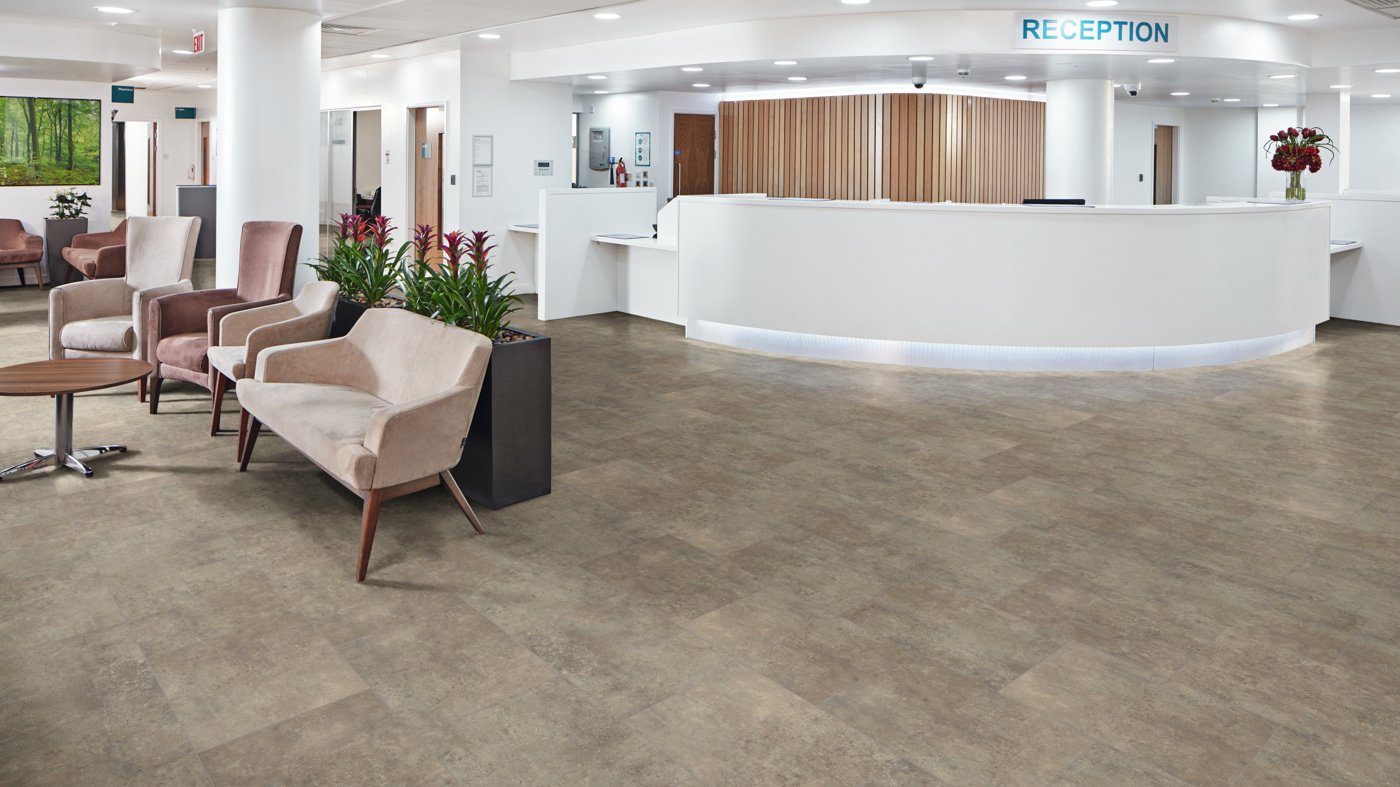 Karndean Korlok luxury vinyl in a hospital lobby showing modern stone-effect design with commercial durability